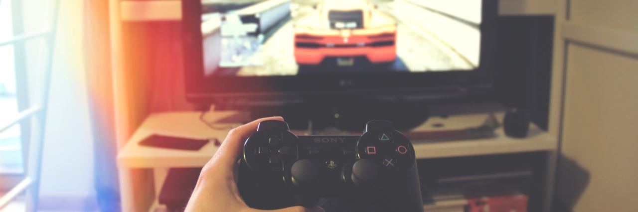 Why It’s Important to Recognize ‘Gaming Disorder’ as a Mental Illness view of playstation controller in front of TV