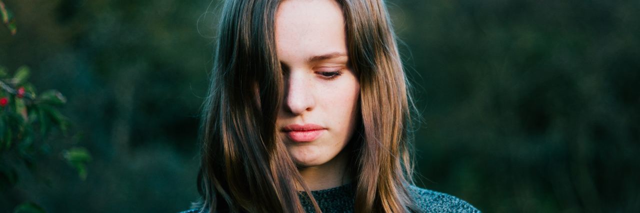 The One Thing I Want to Be Told When I'm Struggling With Depression woman looking down outside