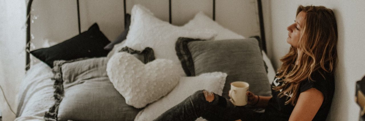 How to Get Motivated When You Have Depression or Anxiety tired woman sitting on bed with cup of coffee