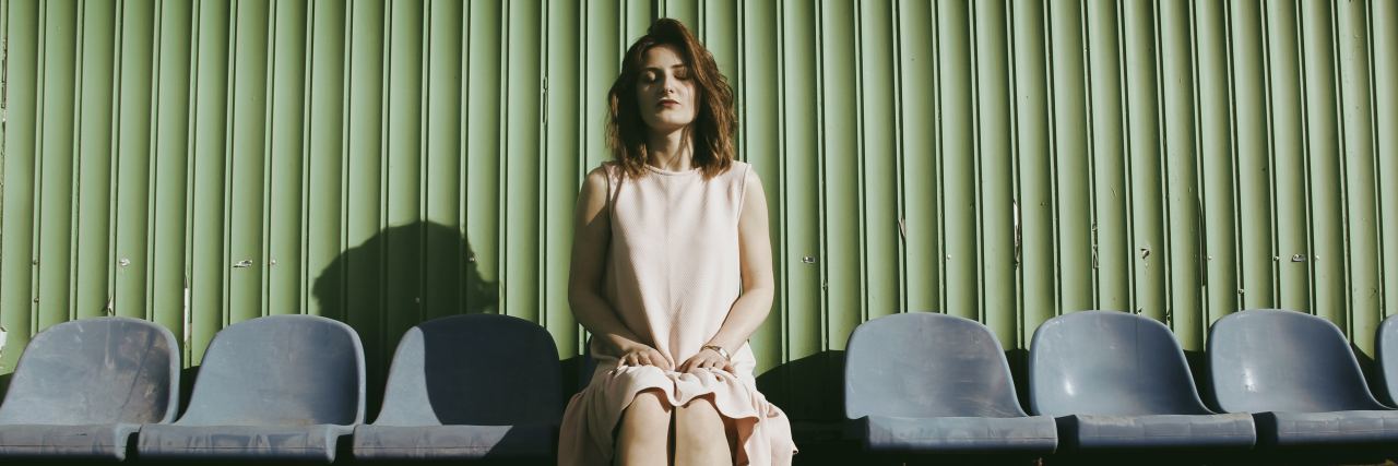 5 Toxic Misconceptions About Suicide No One Should Believe and Why woman sits in empty chairs