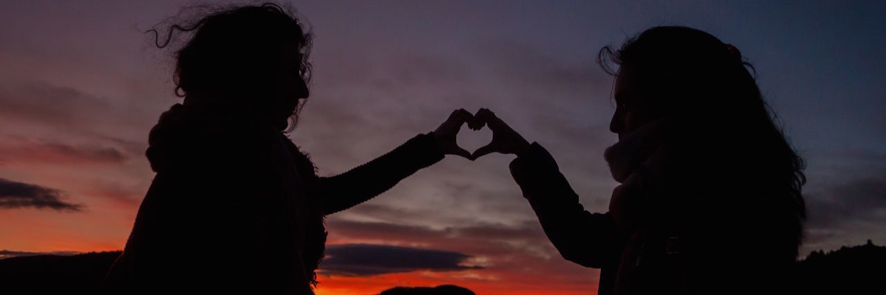 To the Best Friend of the Person in the Psychiatric Hospital Two friends holding up their hands making a heart