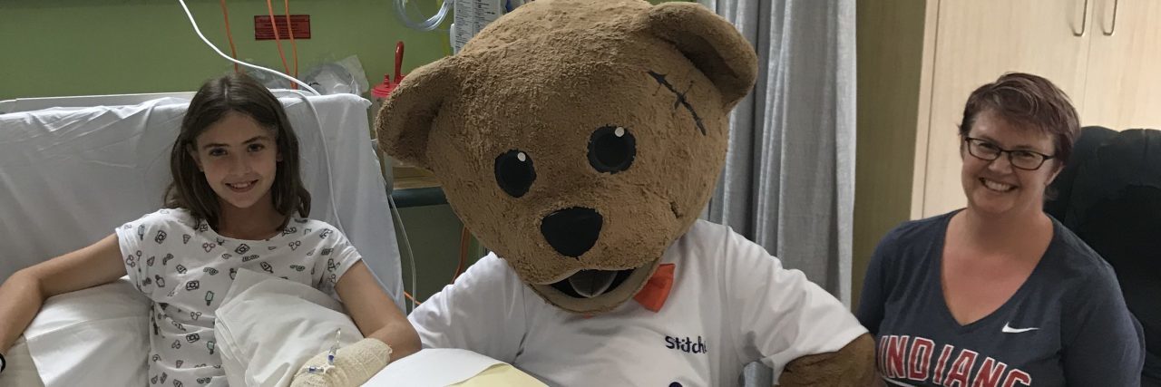 Receiving a Nephrotic Syndrome Diagnosis for Your Child the author's daughter in the hospital with a giant teddy bear