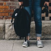 A woman holding a backpack