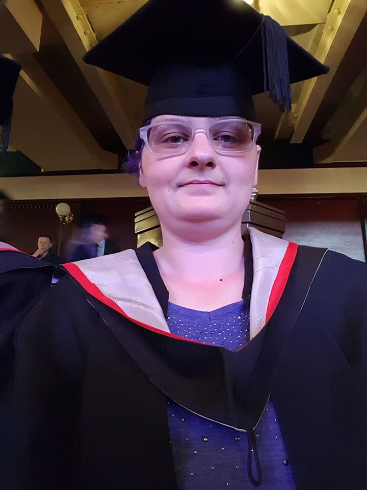 woman wearing a graduation cap and gown