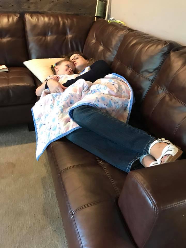 woman sleeping on the couch with her daughter