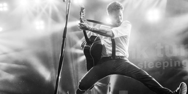 To Frank Turner, From a Disabled Concertgoer Frank Turner rocking out on guitar at a concert.
