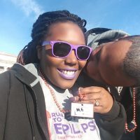 Essence gets a kiss from her partner while at an epilepsy awareness event.