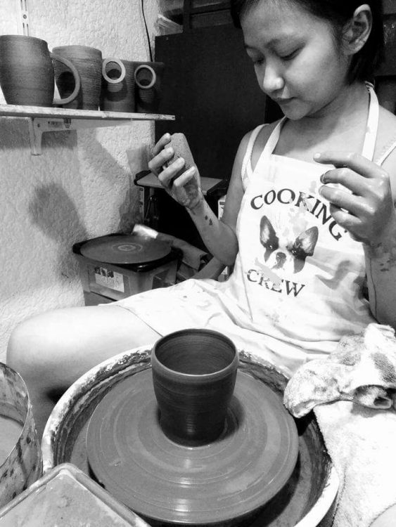 black and white photo of a woman doing pottery