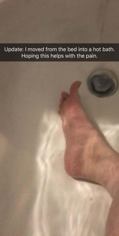 foot under water in bathtub