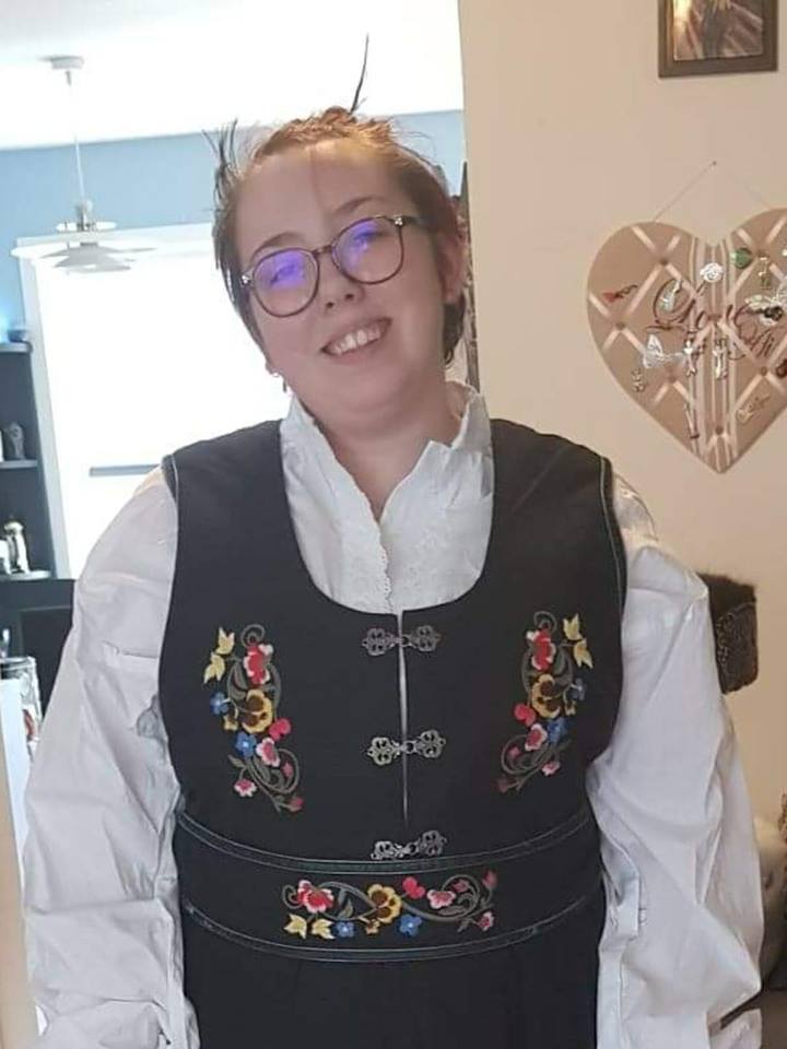 woman wearing a black vest and glasses