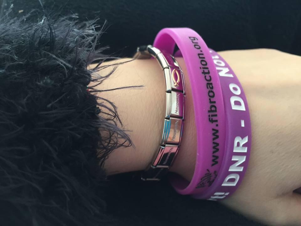 purple wristbands on a woman's wrist