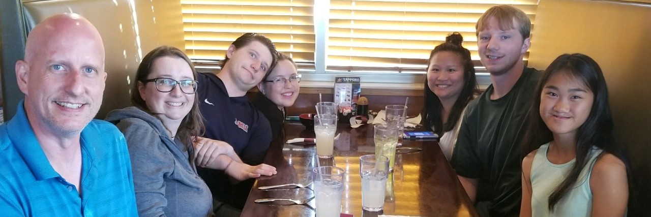 5 Things to Consider If You Want to Support Me and My Chronic Illness The writer with a group of friends, all sitting at a table.