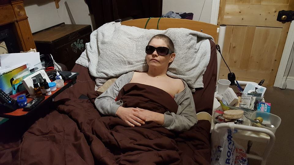 woman lying in bed wearing sunglasses