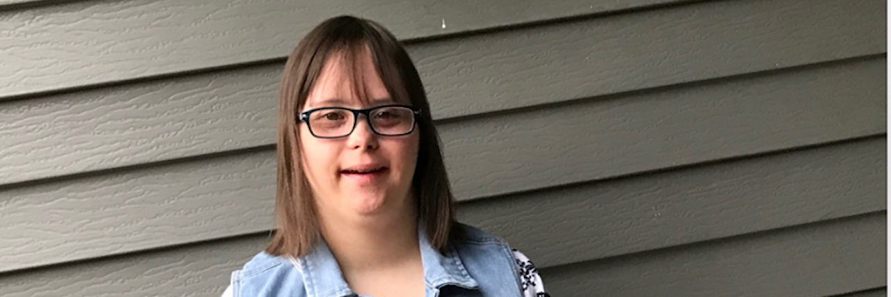 My Daughter With Down Syndrome Wants to Move Out of the House Young woman with Down syndrome posing for camera