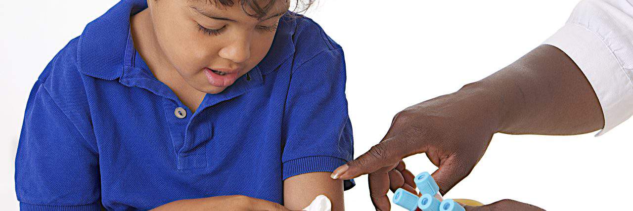 When My Son's Phlebotomist Made Me Cry Child applying pressure to arm after having blood drawn.