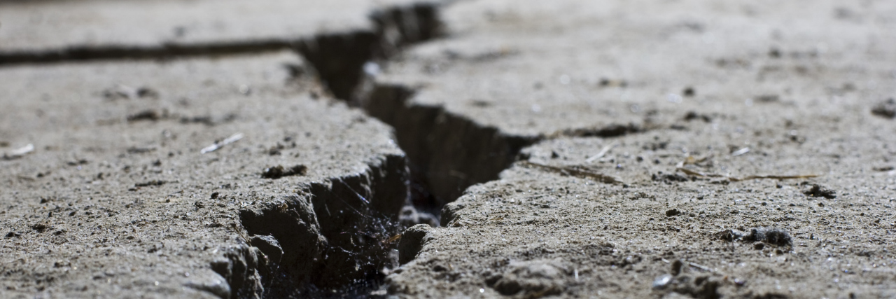Getting Disability Benefits for Mental Illness Cracked road concrete close up.