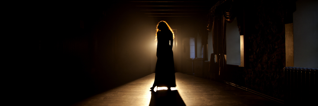 Writing a Play About Hemiplegia Cerebral Palsy Woman in shadows on stage.