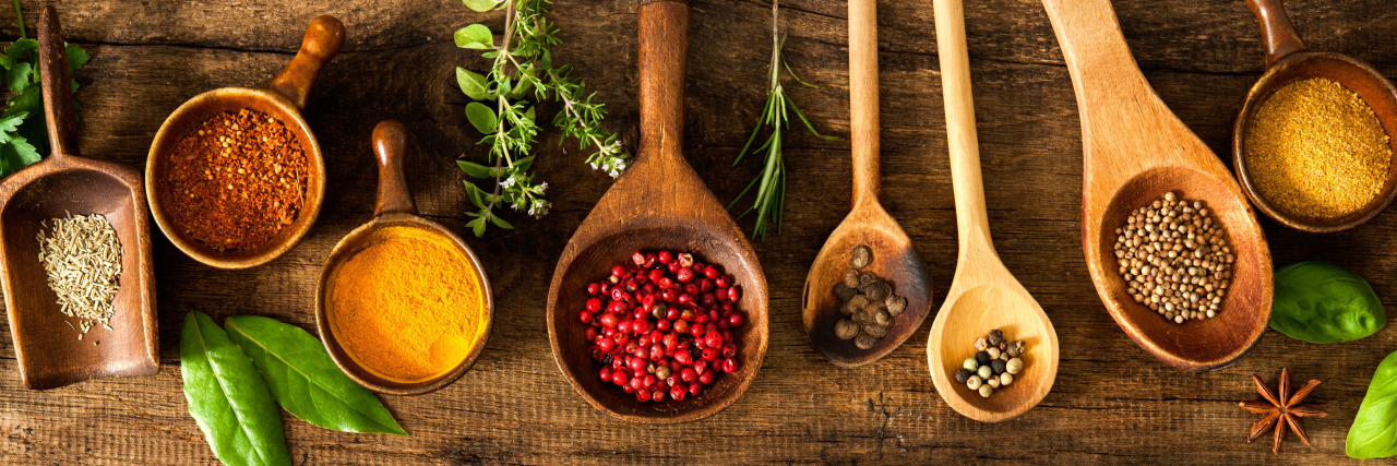 A Recipe for Asking for Help When You Have a Disability Cookbook and spices on wooden table.