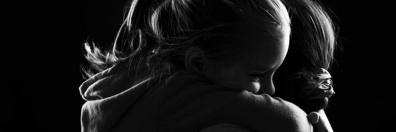 Receiving an Okur-Chung Neurodevelopmental Syndrome Diagnosis Black and white image of a little girl hugging her mother