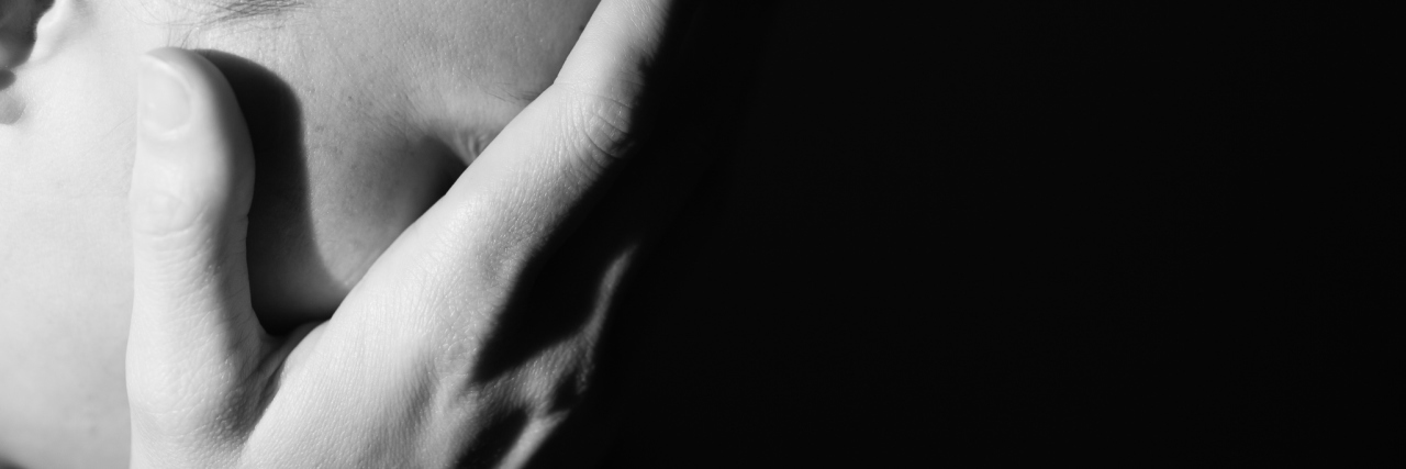 Coping With Multiple Sclerosis-Induced Anxiety black and white photo of a woman holding her head in her hands