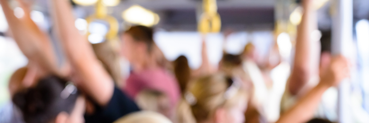 Response to Post Asking Women to Wear Less Perfume Blurred background image of people travelling on an airport bus standing holding onto the roof straps as they are transported out to the aircraft