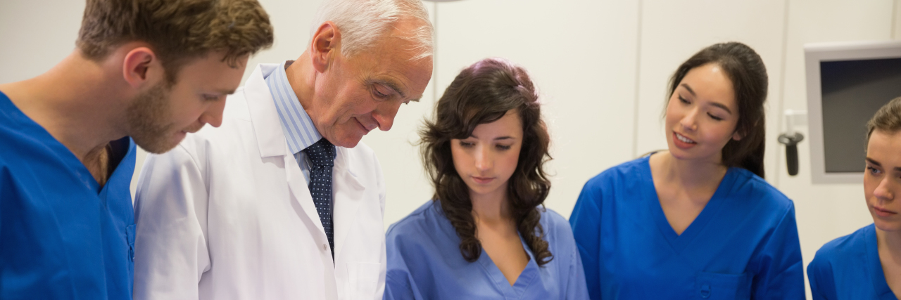 Doctors and Disability Sensitivity Training Medical students and professor examining patient.