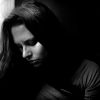 black and white portrait of young woman looking away in sadness and depression