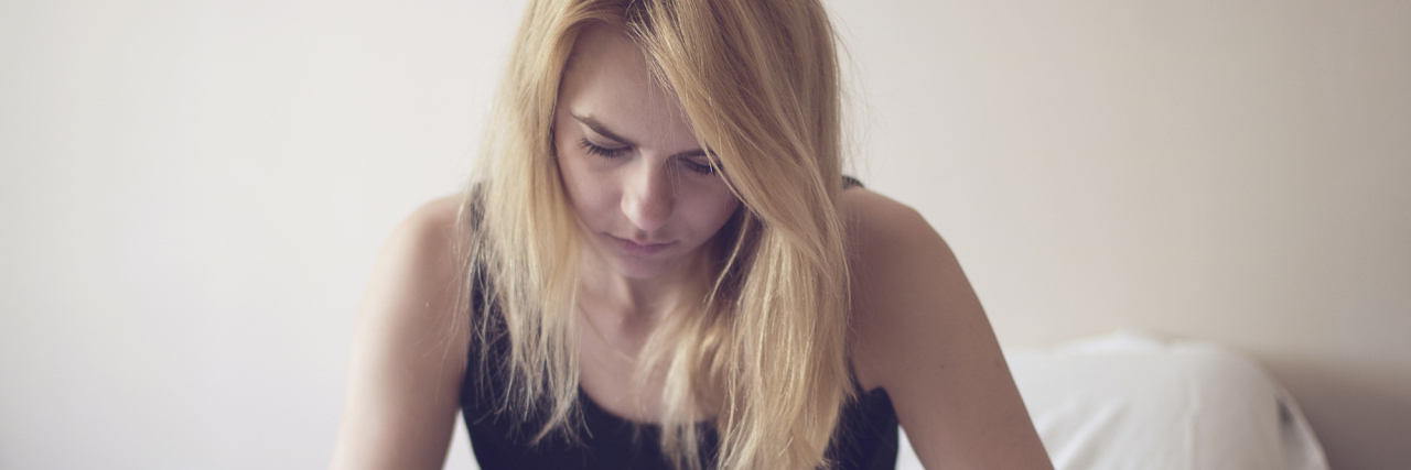 The 'Drunk Texts' I Send When I'm Depressed Blonde woman using smart phone in bed