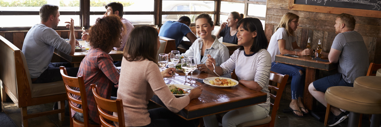 Using the Word 'Crippled' to Describe People With Disabilities Four female friends at lunch in busy restaurant