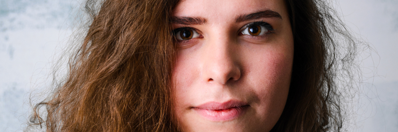 How Neurofeedback Can Help With Depression A portrait of a woman with a serious expression.