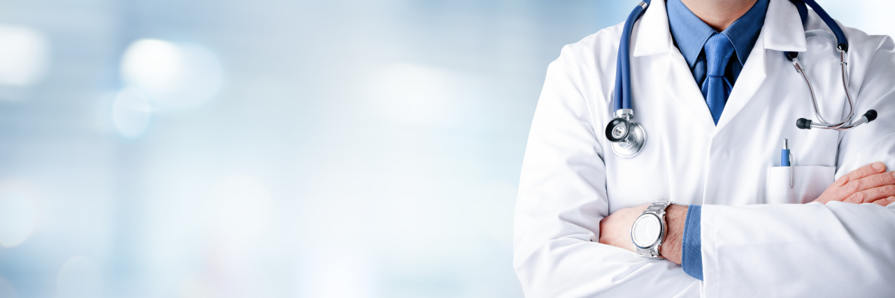 Health Practitioners Need to Stop Shaming and Judging People doctor with a stethoscope around his neck crossing his arms