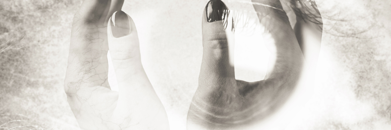 What Sensory Overload Feels Like During a Migraine A double-exposure image,showing a bright eye and hands.