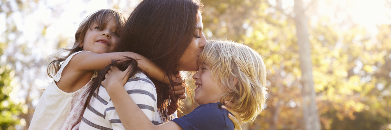 Celebrating Mother's Day as a Chronically Ill Mom mother carrying son and daughter in the park