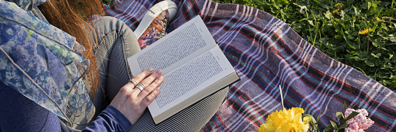 Lessons From Izzy, Willy Nilly About Disability Young woman relaxing with a good book.