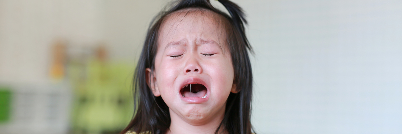 Close up Little girl crying with tears on her face.