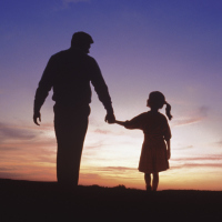 A father and daughter walking and holding hands.