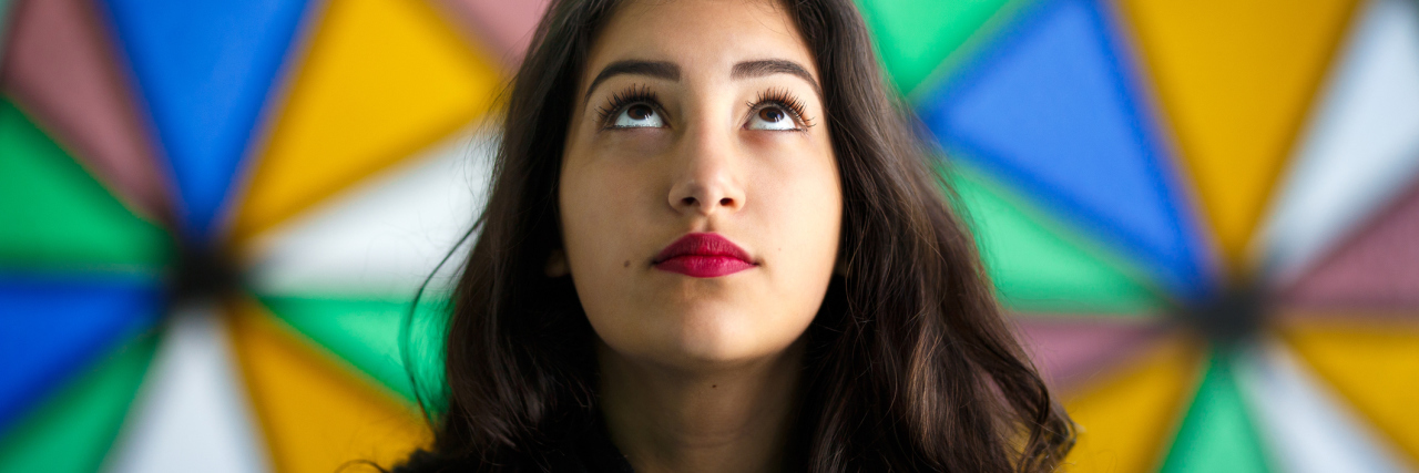 Deciding When to Seek Help for Chronic Illness Symptoms Girl looking up in front of a stained glass window