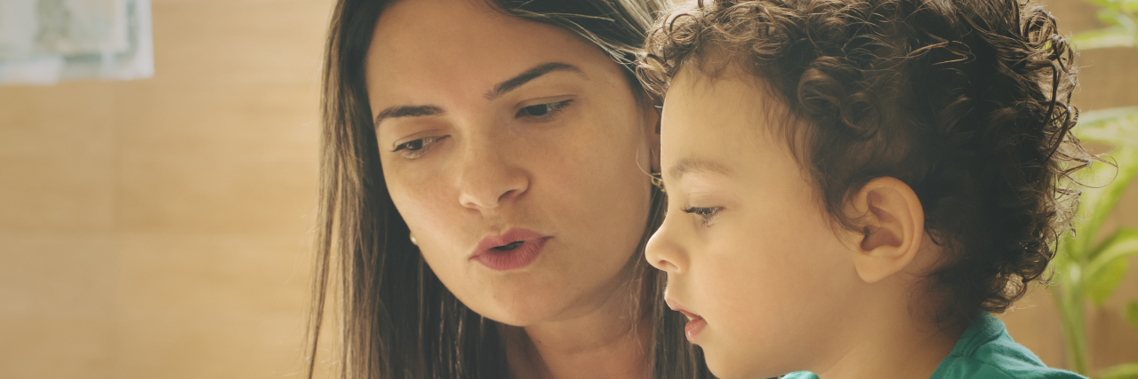 10 Things Not to Say to Parents of Autistic Children Mother teaching her two years old son with a children's book.