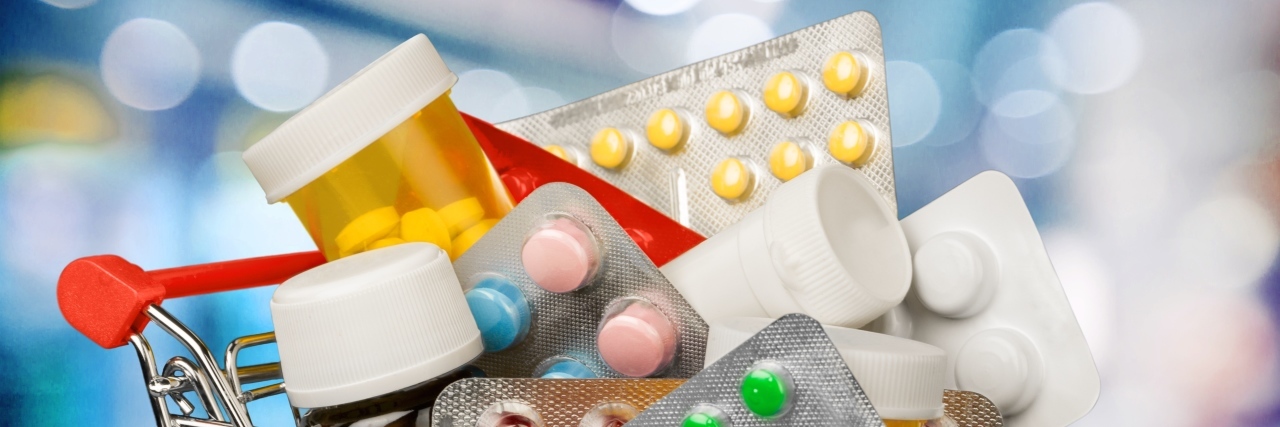 Unsolicited Medical Advice on the Internet Shopping cart with pills.