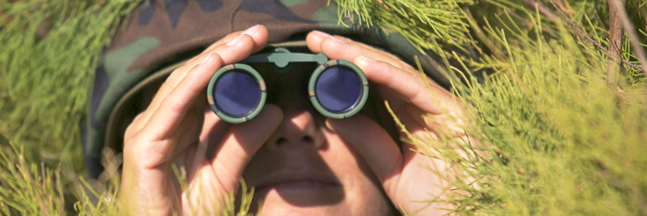 Aspergian Asylum-Seeker: a Poem Soldier using binoculars.