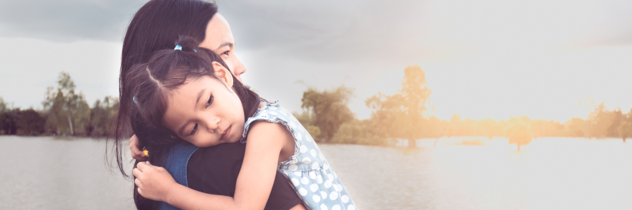 Why Helping an Anxious Child Feel Safe Is the End Game Mother holding tight to daughter who is resting her head on mom's shoulder