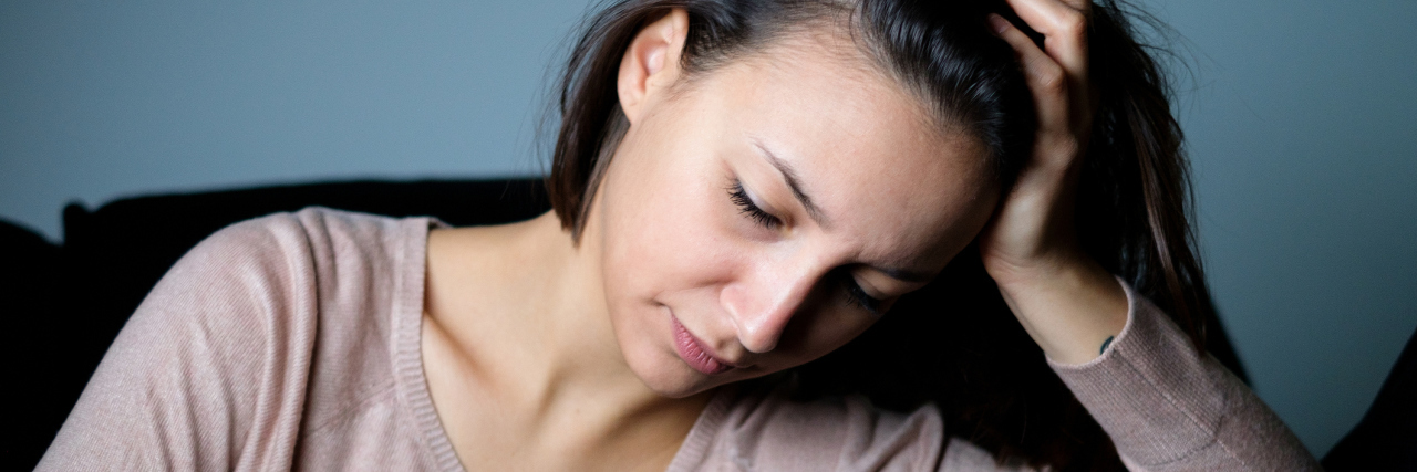 When People Criticize My Illness Management but Don't Help Me sad woman sitting at home and looking at her phone