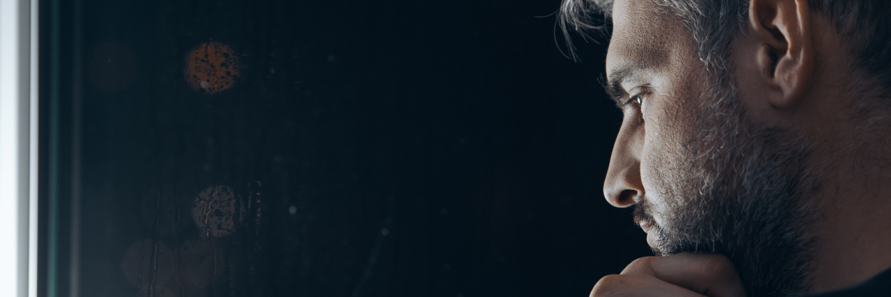 What I'm Learning as I Start My First Day of Long-Term Medical Leave A man sitting in the dark, thinking.