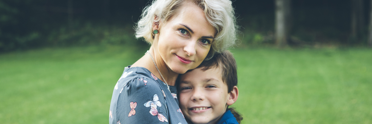 To My Son, Who Helped Me Realize I Am 'Enough' – Illness and All A mom and a young son hugging one another, looking at the camera.