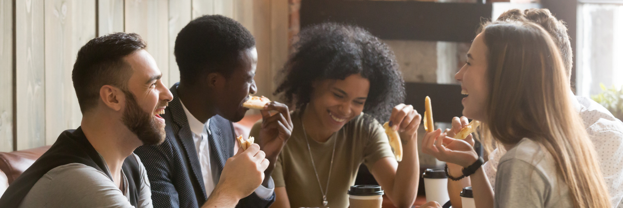 A group of friends talking over lunch.