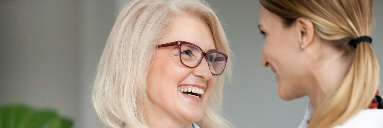 4 Ways I Can Better Honor My Mother as My Caregiver A mom and daughter smiling at one another.