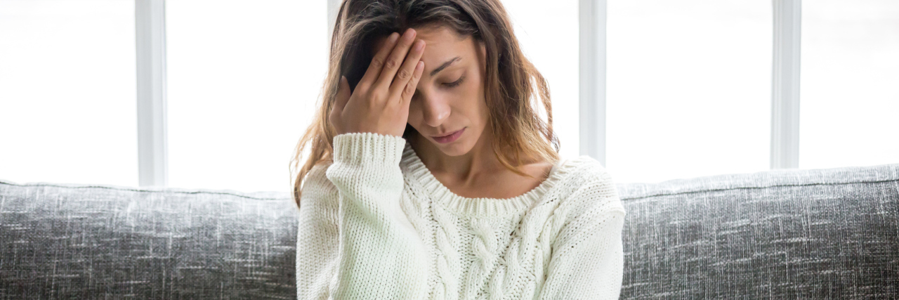 How to Deal With News Trauma When You Have PTSD woman upset or frustrated by online news