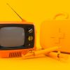 A picture of an orange TV with orange medical supplies, in front of an orange background.