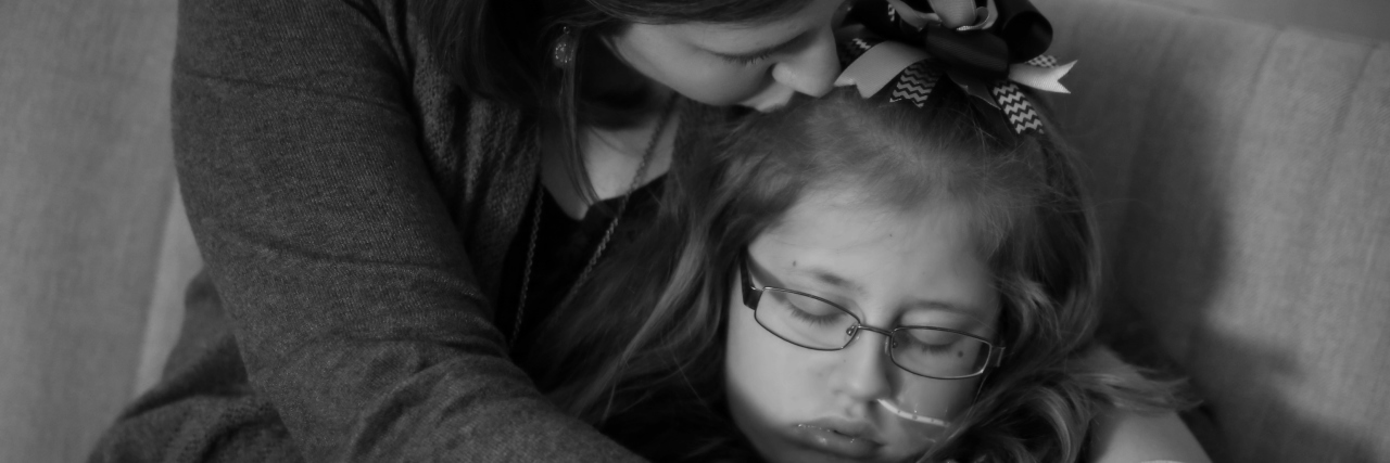 What to Say to Families Whose Children Are in the Hospital The author holding her daughter with a tube in her nose and giving her a kiss