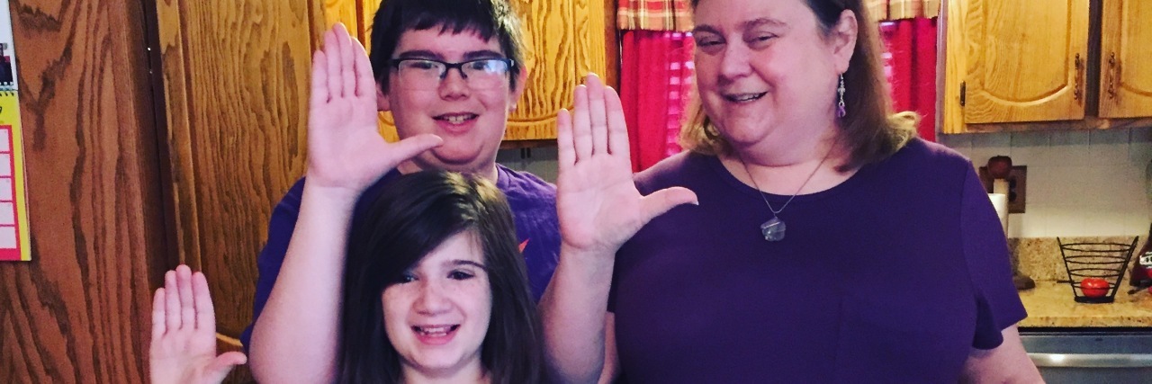 Why I'm Speaking Out During Lupus Awareness Month woman with her daughter and son, all wearing purple